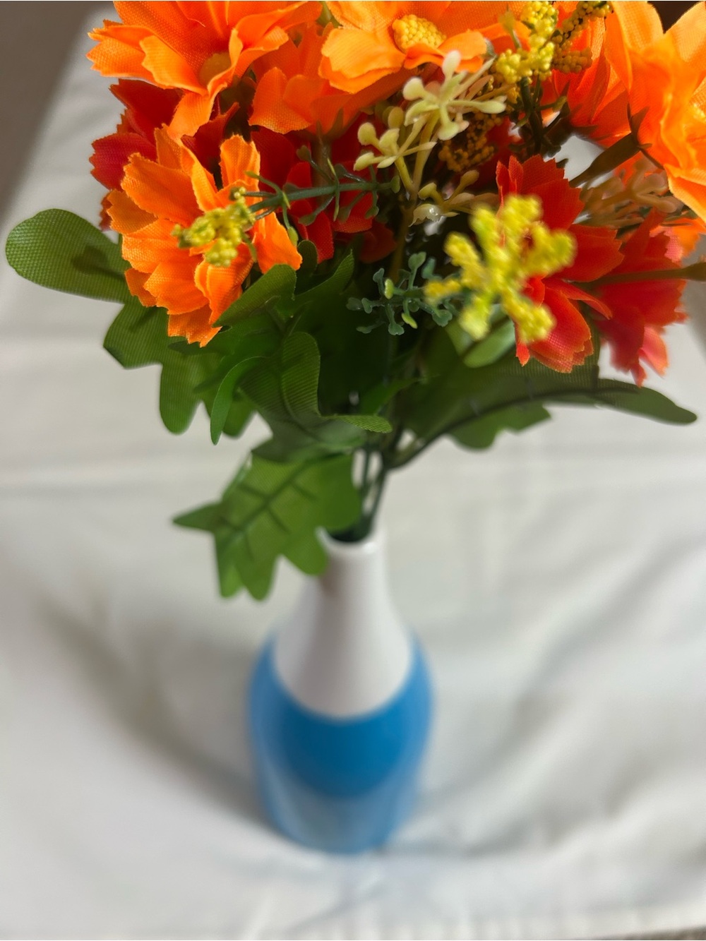 The Spring Shop Orange Floral Arrangement in Blue and White Vase